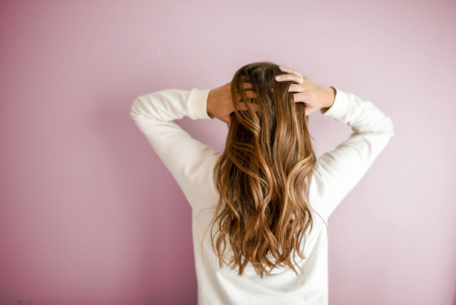 Editorial portrait of long, styled hair for a premium salon hero